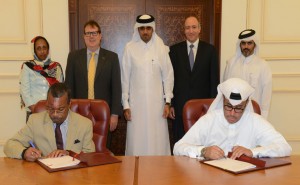  Stephen Blount , Director of Special Health Projects, Carter Center sing the agreement with  Ali Abdullah Al Dabbagh, Executive Director, QDF